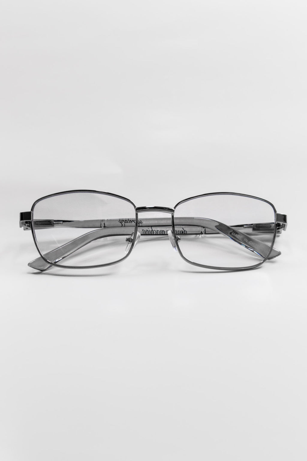Pair of cat eye metal frame glasses with a silver frame on a white background